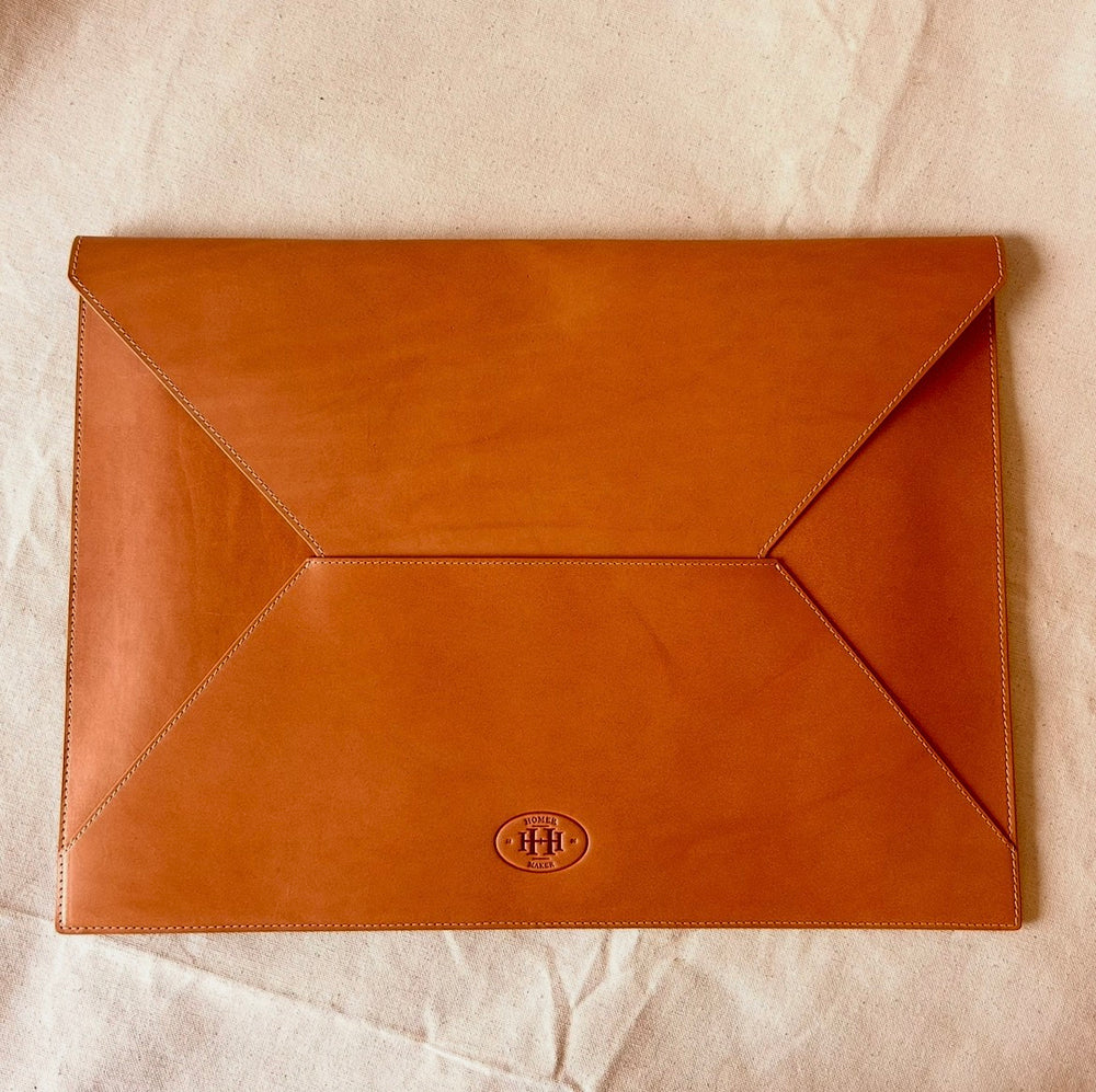 This is a leather folder, which has a nice flap and can carry your laptop or big magazine